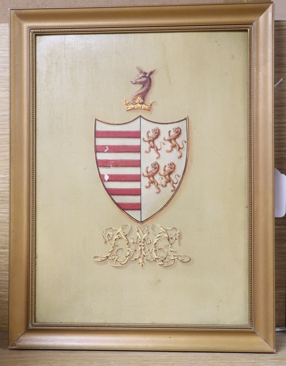 An early 19th century painted millboard armorial, 30 x 22cm